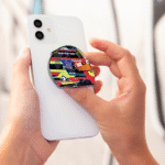 Oscar Piastri helmet-shaped phone grip for smartphones, McLaren Formula 1 inspired accessory in a sleek and functional design.