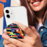 Oscar Piastri helmet-shaped phone grip for smartphones, McLaren Formula 1 inspired accessory in a sleek and functional design.