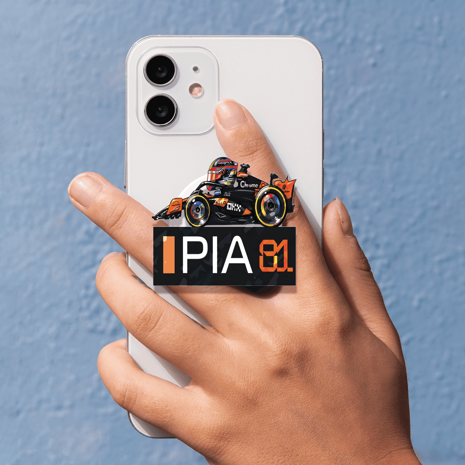 oscar 4 Showcase your racing passion with the Oscar Piastri Miniature F1 2025 Phone Grip. A stylish, functional, and collectible accessory for fans of Formula 1 and McLaren.