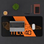 Stealth black MCL40 2026 F1 car blueprint desk mat with papaya orange lines