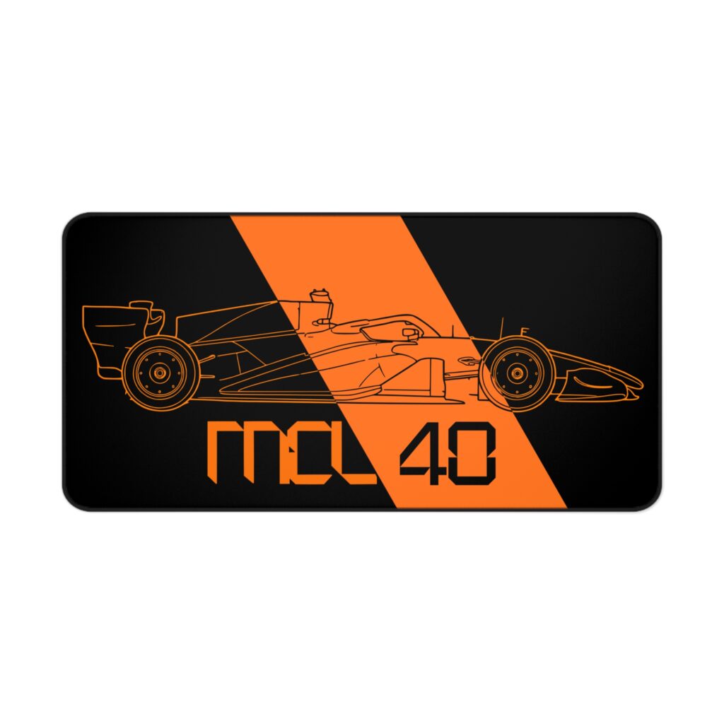 Stealth black MCL40 2026 F1 car blueprint desk mat with papaya orange lines