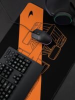 work-178881442-desk-mat (3) Stealth black MCL40 2026 F1 car blueprint desk mat with papaya orange lines