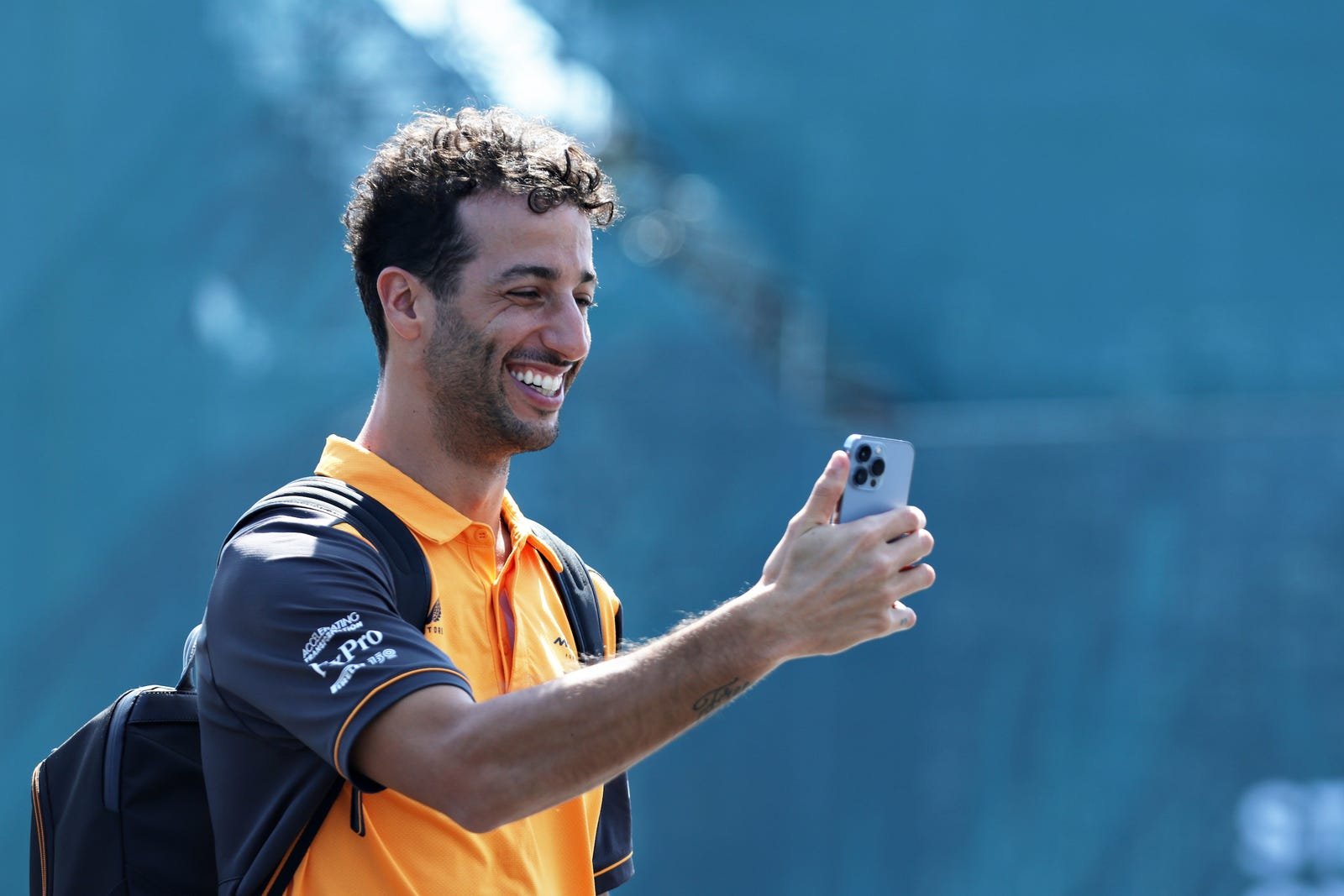 F1 driver in team kit using a smartphone — F1 phone case guide