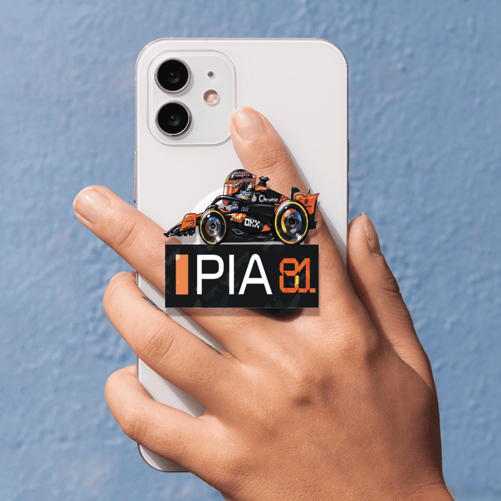 Showcase your racing passion with the Oscar Piastri Miniature F1 2025 Phone Grip. A stylish, functional, and collectible accessory for fans of Formula 1 and McLaren.